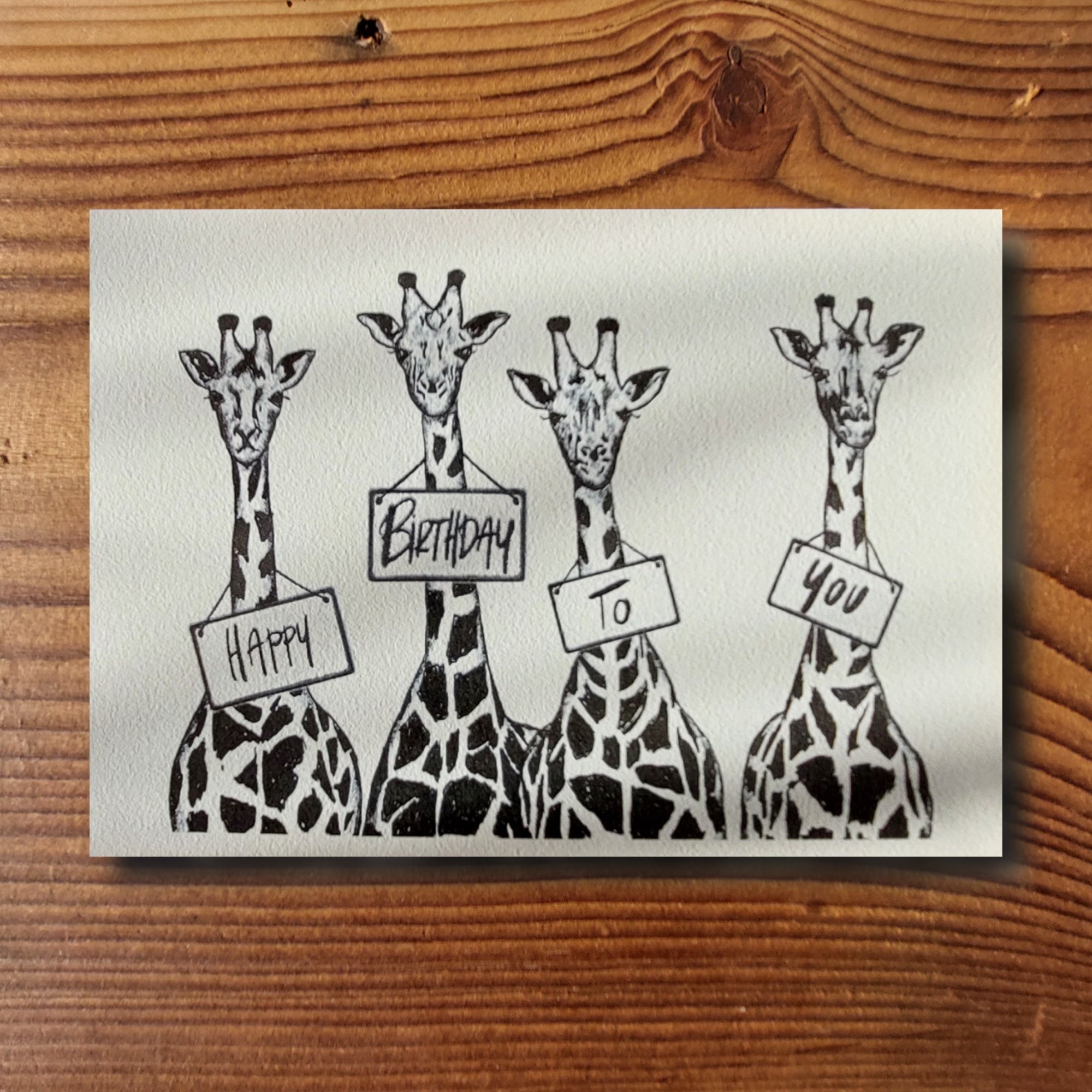 Geburtstagskarte mit vier Giraffen und dem Schriftzug Happy Birthday To You, Schwarz-Weiss-Illustration, A6-Format, KicomiArt

